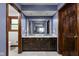 Elegant bathroom featuring a double sink vanity with granite countertops, wood cabinets, and a large mirror at 38 Hawthorne Ct, Carmel, IN 46033