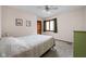 Comfortable bedroom with a bed, a green dresser, and a ceiling fan at 38 Hawthorne Ct, Carmel, IN 46033
