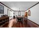 Elegant dining room with hardwood floors, chandelier, and ample natural light at 38 Hawthorne Ct, Carmel, IN 46033