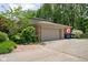 Spacious two-car garage with ample parking and storage, complemented by a well-maintained driveway and garden at 38 Hawthorne Ct, Carmel, IN 46033
