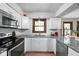 Bright, updated kitchen with white cabinets, granite countertops, and stainless steel appliances at 38 Hawthorne Ct, Carmel, IN 46033