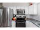 Modern kitchen features stainless steel appliances, granite countertops, and white cabinets at 38 Hawthorne Ct, Carmel, IN 46033