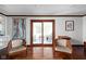 Bright living room with hardwood floors, built-in shelving, and sliding doors to patio at 38 Hawthorne Ct, Carmel, IN 46033