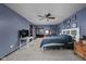 Comfortable carpeted main bedroom showcasing a bed, dresser, shelves, decorations, and ensuite bathroom at 38 Hawthorne Ct, Carmel, IN 46033