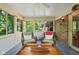 Cozy sunroom with wicker chairs, string lights, and views of the lush backyard at 38 Hawthorne Ct, Carmel, IN 46033