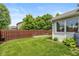 Green backyard featuring wood fence, garden bed, and rain barrel at 4256 Zachary Ln, Westfield, IN 46062