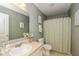 Bathroom with green walls, a framed mirror, and a shower with a curtain at 4256 Zachary Ln, Westfield, IN 46062