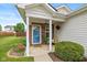 Inviting front porch with hanging flowers, decor, and brick accents creating a warm welcome at 4256 Zachary Ln, Westfield, IN 46062