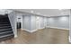 Finished basement area features wood flooring, recessed lighting and neutral walls at 4359 Winthrop Ave, Indianapolis, IN 46205