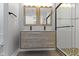 Bathroom features a wood vanity with double sinks and a glass shower at 4359 Winthrop Ave, Indianapolis, IN 46205