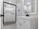 Modern bathroom featuring a glass-enclosed shower with decorative tile and white vanity at 4359 Winthrop Ave, Indianapolis, IN 46205