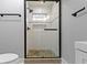 Sleek bathroom featuring a glass enclosed shower with decorative tiles and black fixtures at 4359 Winthrop Ave, Indianapolis, IN 46205