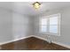 This bedroom offers natural light, wood flooring and neutral gray walls at 4359 Winthrop Ave, Indianapolis, IN 46205
