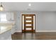 Open floor plan showcases a modern door, adjacent to kitchen and living area with hardwood floors at 4359 Winthrop Ave, Indianapolis, IN 46205