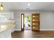 Open-concept living area showcases a modern front door, adjacent to kitchen, and hardwood floors at 4359 Winthrop Ave, Indianapolis, IN 46205