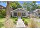 Charming single-story home features a covered front porch, gray siding, and a well-manicured lawn at 4359 Winthrop Ave, Indianapolis, IN 46205
