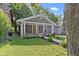 This cozy single-story house has a covered front porch, gray siding, and an inviting front yard at 4359 Winthrop Ave, Indianapolis, IN 46205