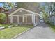 Single-story home with gray siding, covered porch, well-maintained lawn, and private driveway at 4359 Winthrop Ave, Indianapolis, IN 46205