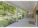Covered front porch with sleek railings, seating area, and a view of the landscaped front yard at 4359 Winthrop Ave, Indianapolis, IN 46205