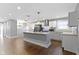Open kitchen featuring stainless steel appliances, white cabinetry, and a granite island at 4359 Winthrop Ave, Indianapolis, IN 46205
