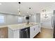 Kitchen island and open living area featuring modern pendant lights and stainless steel appliances at 4359 Winthrop Ave, Indianapolis, IN 46205