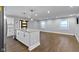 Kitchen island featuring stainless steel dishwasher, cabinets and a view of the open living area at 4359 Winthrop Ave, Indianapolis, IN 46205