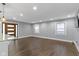 Spacious living room with hardwood floors, recessed lighting, and modern windows at 4359 Winthrop Ave, Indianapolis, IN 46205
