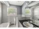 Traditional bathroom featuring a vanity with a black countertop and white-tiled walls and floors at 4622 S Franklin Rd, Indianapolis, IN 46239
