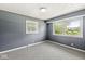 Cozy bedroom with neutral walls, large windows, and carpeted floors at 4622 S Franklin Rd, Indianapolis, IN 46239