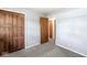 Bedroom with neutral-colored walls, a spacious closet, and an open doorway leading to another room at 4622 S Franklin Rd, Indianapolis, IN 46239