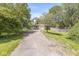 Long driveway leading to a well-maintained home surrounded by lush greenery and mature trees at 4622 S Franklin Rd, Indianapolis, IN 46239