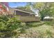 Charming exterior view of home featuring a spacious wooden deck and mature landscaping in a lush backyard at 4622 S Franklin Rd, Indianapolis, IN 46239