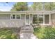 Inviting front entrance with a stone walkway, modern windows, and stylish exterior lighting at 4622 S Franklin Rd, Indianapolis, IN 46239