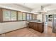 Eat-in kitchen features wood floors, stainless appliances, and an island cooktop with breakfast bar seating at 4622 S Franklin Rd, Indianapolis, IN 46239