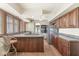 Bright kitchen featuring stainless appliances, wood cabinetry, island cooktop and plenty of natural light at 4622 S Franklin Rd, Indianapolis, IN 46239