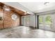 Recreation room with natural light, wood-paneled accent wall and slate floors at 4622 S Franklin Rd, Indianapolis, IN 46239