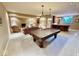 Basement with a pool table, seating area, and wet bar for entertaining at 5200 W Shoreline Ter, Muncie, IN 47304