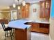 Basement wet bar featuring a sink, cabinets, countertop, and pendant lighting at 5200 W Shoreline Ter, Muncie, IN 47304