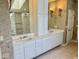 Bathroom features a double sink vanity with white cabinets, decorative sconces, and a mirrored wall at 5200 W Shoreline Ter, Muncie, IN 47304