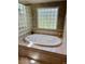A bathtub in bathroom with glass block window at 5200 W Shoreline Ter, Muncie, IN 47304
