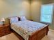 A bedroom featuring neutral walls, wood frame bed, and a bright window at 5200 W Shoreline Ter, Muncie, IN 47304