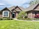 Charming brick home with well-manicured front lawn and mature landscaping at 5200 W Shoreline Ter, Muncie, IN 47304