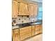 Close up showcasing the wood cabinets, tile backsplash, granite countertops, and cooktop at 5200 W Shoreline Ter, Muncie, IN 47304