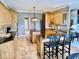 Charming kitchen featuring wood cabinets, black appliances, a center island, and tiled floors at 5200 W Shoreline Ter, Muncie, IN 47304