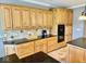 Kitchen area features wood cabinetry, granite counters, tile backsplash, and black appliances at 5200 W Shoreline Ter, Muncie, IN 47304