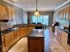 Kitchen area boasts wood cabinetry, black countertops, stainless steel appliances, and tile flooring at 5200 W Shoreline Ter, Muncie, IN 47304