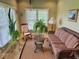 Cozy sun room with wicker furniture, a rocking chair, a large window, and natural lighting at 5200 W Shoreline Ter, Muncie, IN 47304