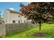 Fenced backyard with green lawn and a shade tree at 5361 Cradle River Ct, Indianapolis, IN 46221