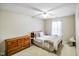 Bedroom features neutral paint, ceiling fan and a window with soft, natural light at 5361 Cradle River Ct, Indianapolis, IN 46221