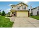 Charming two-story home features a well-manicured lawn, brick accents, and an attached two-car garage at 5361 Cradle River Ct, Indianapolis, IN 46221